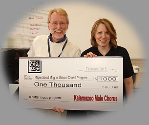 KMC director presenting check to Maple St. School vocal music director